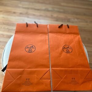 Two Hermes Orange Shopping Bags with Logos
